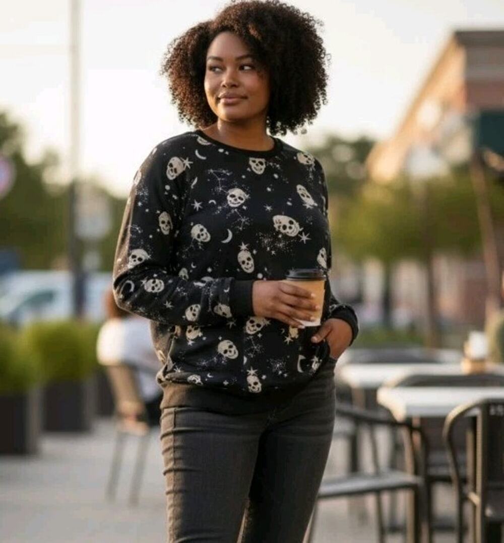 Torrid black long-sleeve sweatshirt featuring a celestial skull and star print.